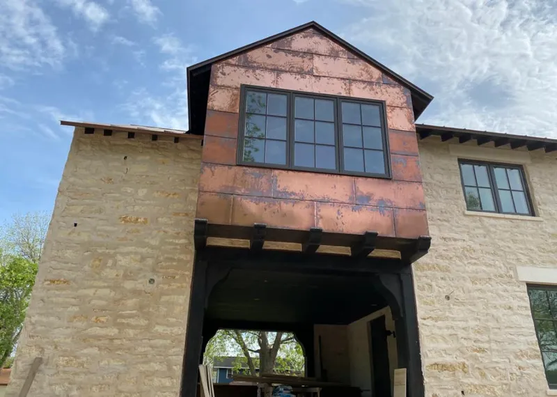 Copper metal panel facade on a stone building for Skylight Installation in Mobile