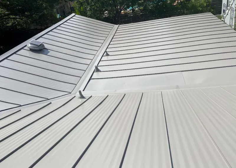 Solar attic fan installed on a metal roof for Roof Ventilation in Mobile